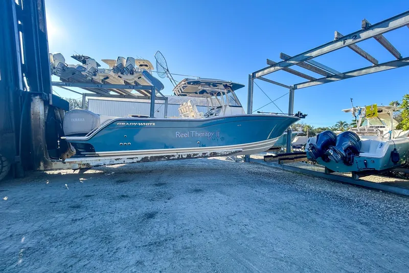 Slide: The Image of 2021 Grady-White Freedom 325 boat in storage, featuring Yamaha engines. - 3