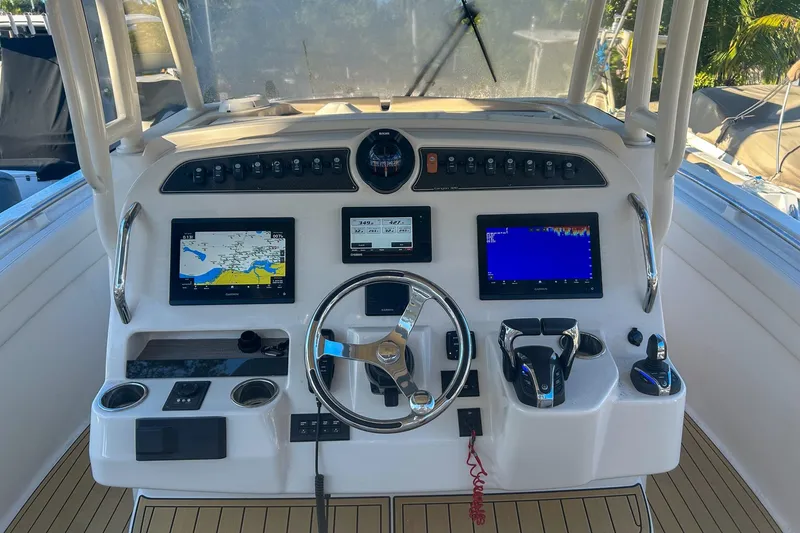 Slide: The Image of Helm of 2021 Grady-White Freedom 325 boat with navigation screens and controls. - 6