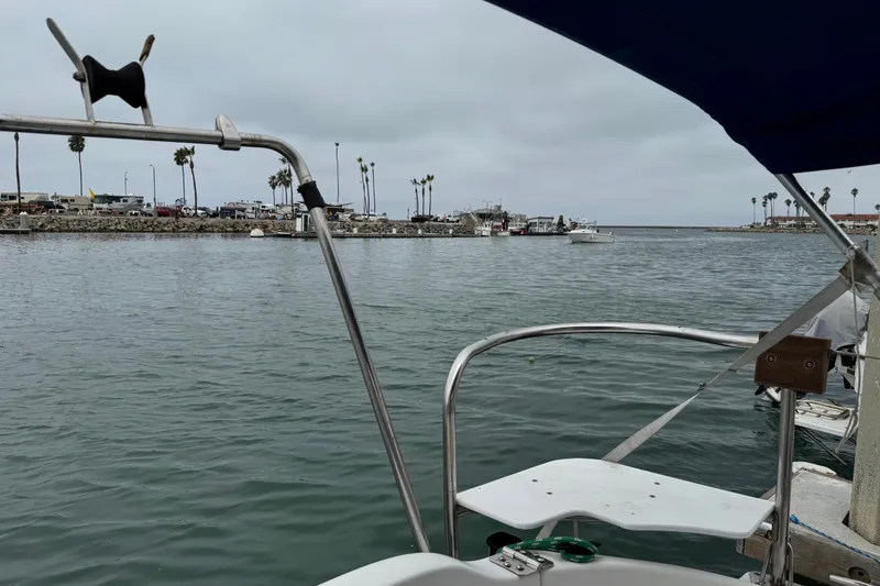 Slide: The Image of View from a 2005 MacGregor 26M Powersailer, overlooking a marina with palm trees. - 18