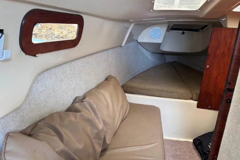 Slide: The Image of Interior of 2005 MacGregor 26M Powersailer with cozy seating and sleeping area. - 22