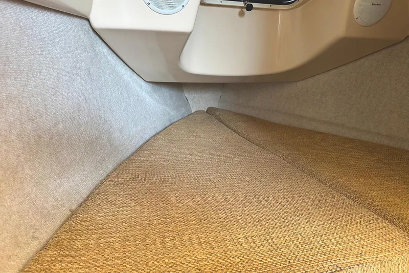 Slide: The Image of Interior cabin of 2005 MacGregor 26M Powersailer with beige upholstery and speaker system. - 23