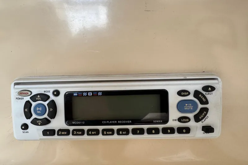 Slide: The Image of Jensen MCD5112 CD player receiver on 2005 MacGregor 26M Powersailer dashboard. - 29