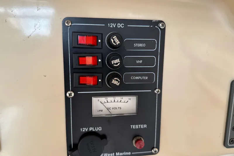 Slide: The Image of Control panel of a 2005 MacGregor 26M Powersailer with 12V DC switches and voltmeter. - 30