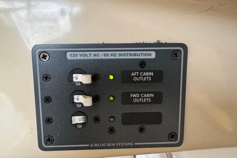 Slide: The Image of Electrical panel on 2005 MacGregor 26M Powersailer, featuring 120V AC distribution and circuit breakers. - 31
