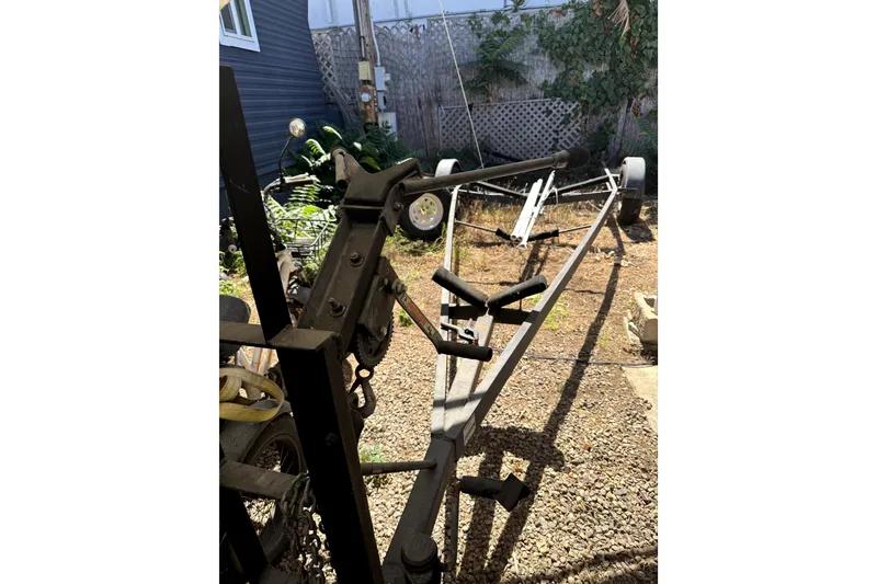 Slide: The Image of Boat trailer for 2005 MacGregor 26M Powersailer in a yard setting. - 33