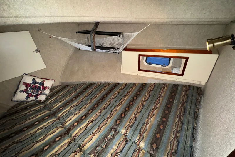 Slide: The Image of Interior cabin of 2004 Camano 31 Troll boat with patterned bedding and decorative pillow. - 13