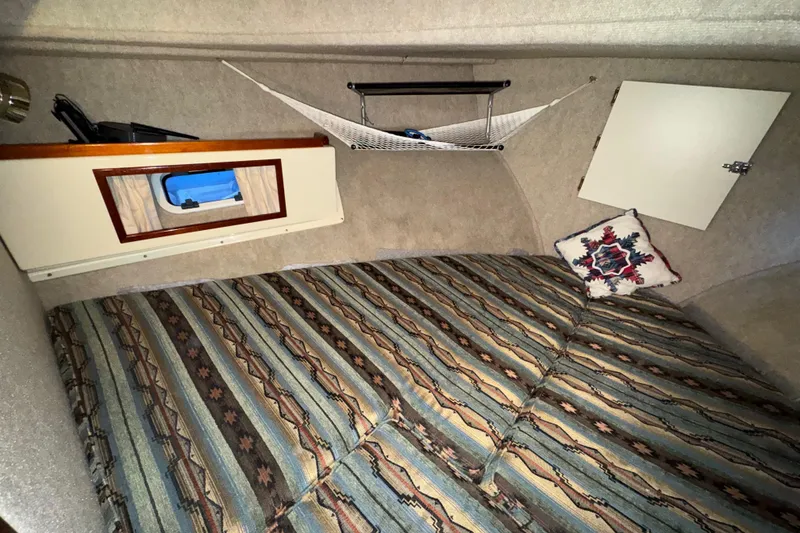 Slide: The Image of Interior cabin of 2004 Camano 31 Troll boat with patterned bedding and storage. - 14