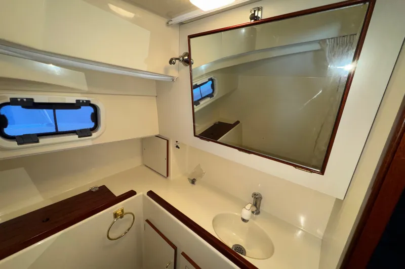 Slide: The Image of Bathroom interior of 2004 Camano 31 Troll boat with mirror and sink. - 16