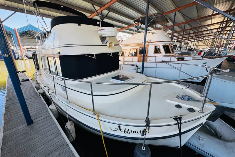 Slide: The Image of 2004 Camano 31 Troll boat docked in a covered marina. - 18