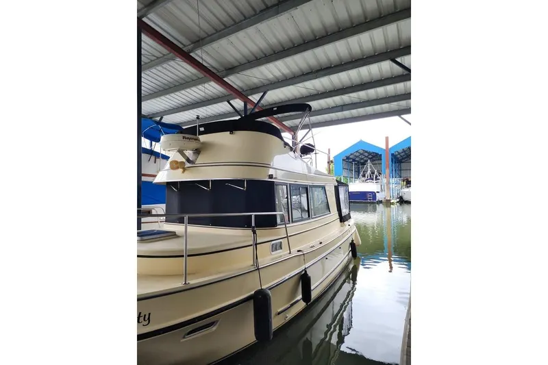 Slide: The Image of 2004 Camano 31 Troll boat docked in covered marina, side view. - 2