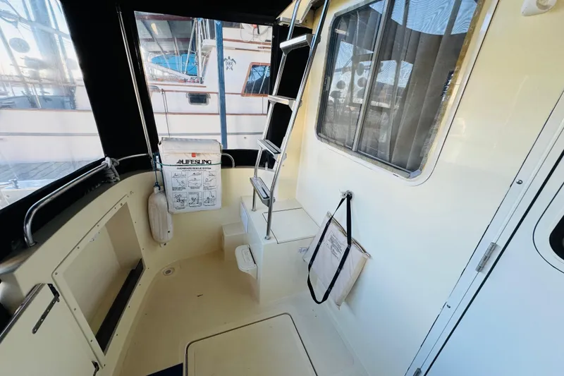 Slide: The Image of 2004 Camano 31 Troll boat interior with ladder, window, and safety equipment. - 25