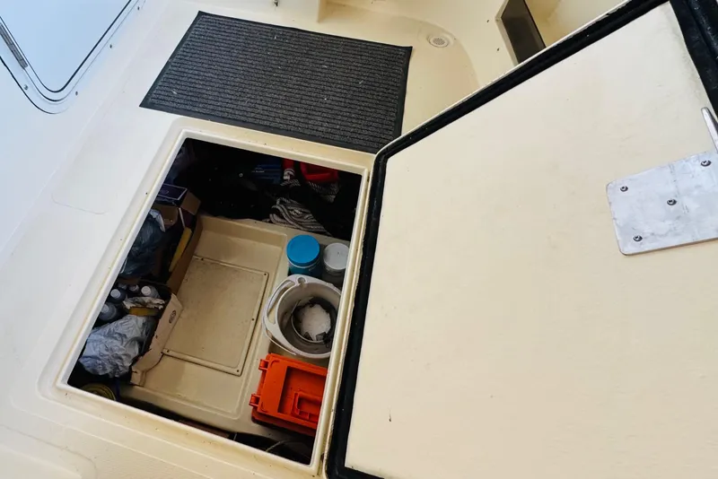 Slide: The Image of Storage compartment on a 2004 Camano 31 Troll boat, containing various supplies and equipment. - 28