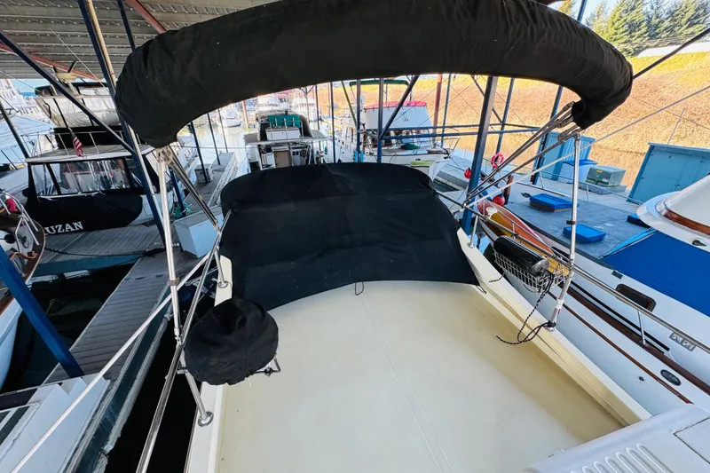 Slide: The Image of 2004 Camano 31 Troll boat docked under a covered marina. - 29