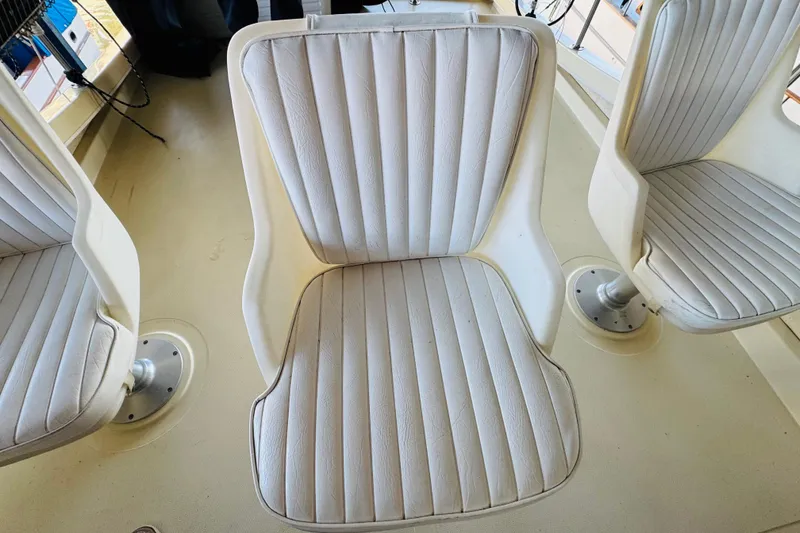 Slide: The Image of White cushioned seats on a 2004 Camano 31 Troll boat deck. - 36