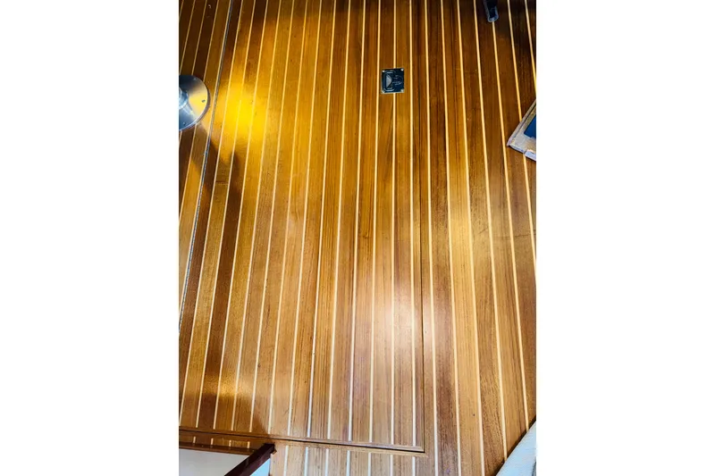 Slide: The Image of Polished wooden deck of 2004 Camano 31 Troll boat, featuring sleek lines and warm tones. - 39