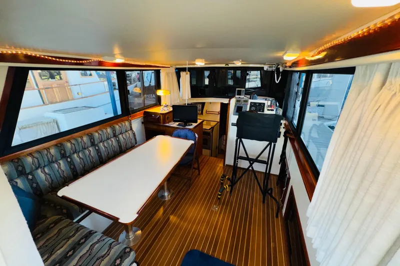 Slide: The Image of Interior of 2004 Camano 31 Troll boat with seating, table, and navigation area. - 4