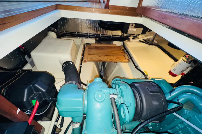 Slide: The Image of Engine room of 2004 Camano 31 Troll boat, showcasing mechanical components and storage. - 40