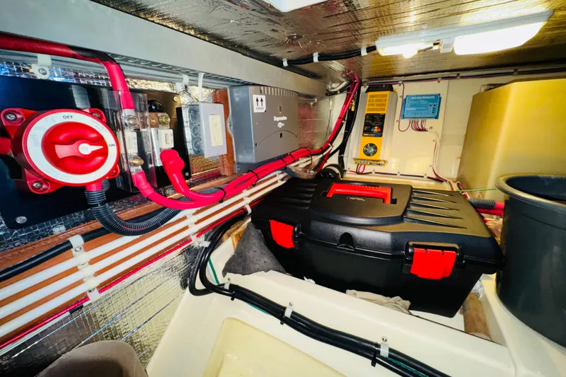 Slide: The Image of Electrical system inside a 2004 Camano 31 Troll boat, featuring wiring and control panels. - 43