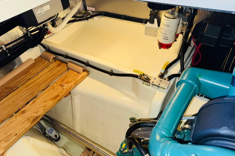 Slide: The Image of Engine room of 2004 Camano 31 Troll boat, showcasing mechanical components and fuel system. - 46