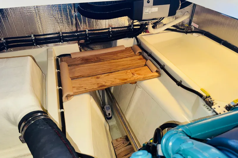 Slide: The Image of Engine compartment of a 2004 Camano 31 Troll boat, featuring organized wiring and components. - 47