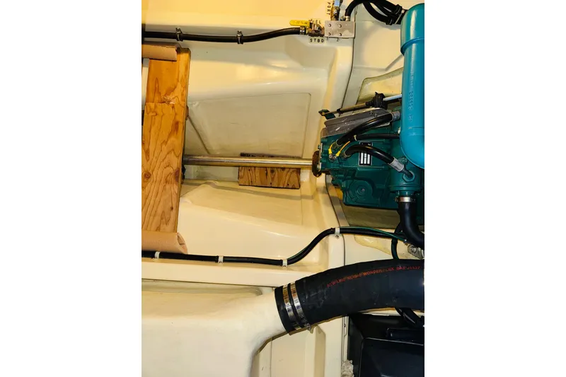 Slide: The Image of Engine compartment of a 2004 Camano 31 Troll boat, showcasing mechanical components. - 48