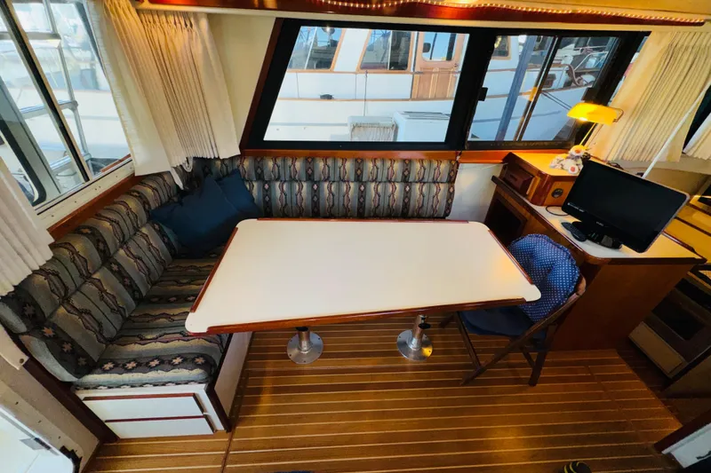 Slide: The Image of Interior of 2004 Camano 31 Troll boat with dining area and computer setup. - 5