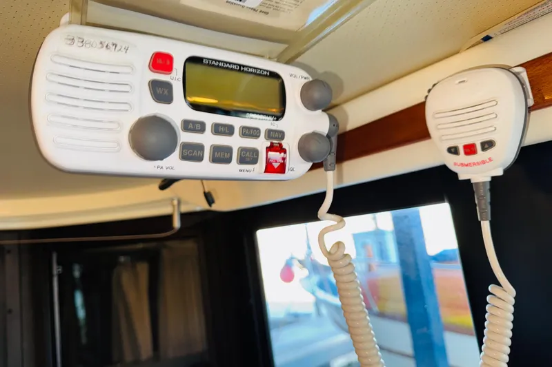 Slide: The Image of VHF radio equipment inside a 2004 Camano 31 Troll boat cabin. - 50