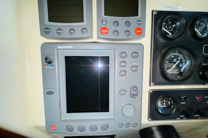 Slide: The Image of Control panel of a 2004 Camano 31 Troll boat with Raymarine electronics. - 55