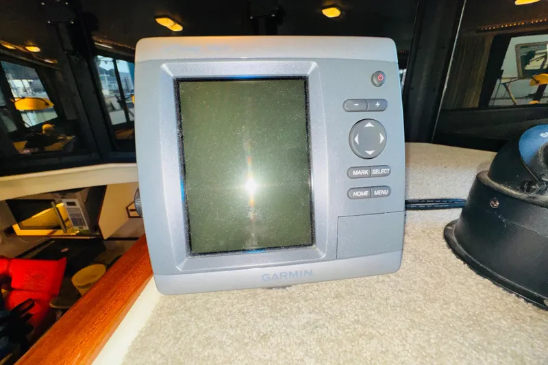 Slide: The Image of Garmin GPS device on 2004 Camano 31 Troll boat dashboard. - 56