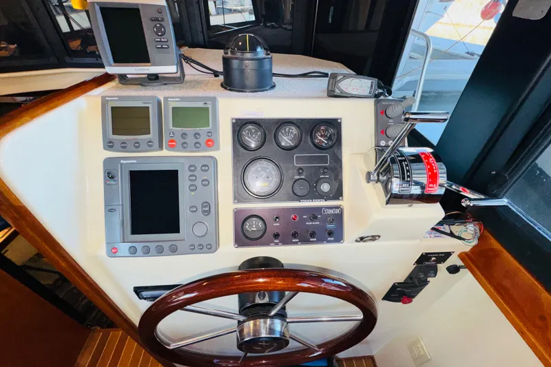 Slide: The Image of Control panel of a 2004 Camano 31 Troll boat with navigation instruments. - 57