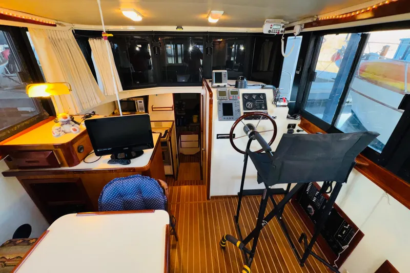Slide: The Image of Interior of 2004 Camano 31 Troll boat with helm, seating, and navigation equipment. - 6