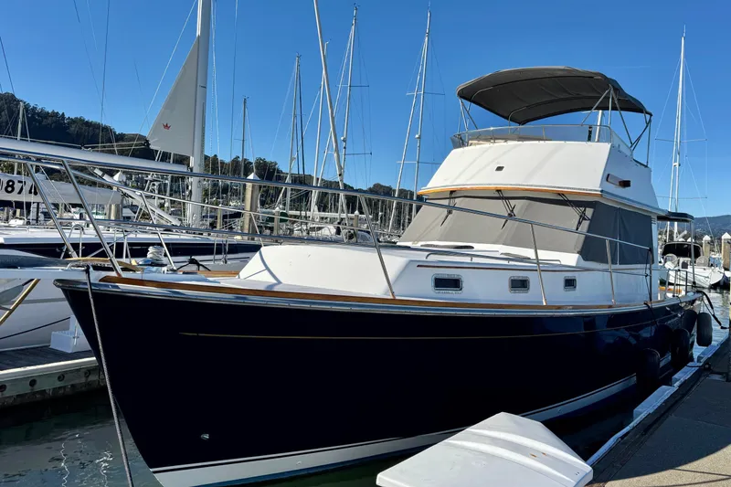 Slide: The Image of 2001 Sabre Sedan Bridge yacht docked at marina with clear blue sky. - 0