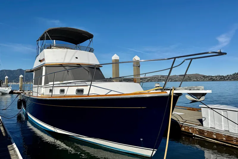 Slide: The Image of 2001 Sabre Sedan Bridge yacht docked at marina under clear blue sky. - 1