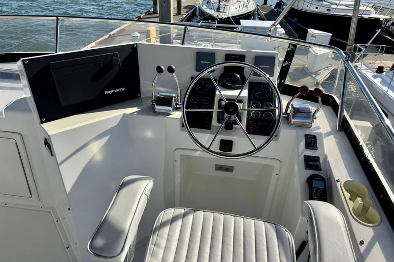 Slide: The Image of 2001 Sabre Sedan Bridge helm with Raymarine electronics, featuring steering wheel and control panel. - 10