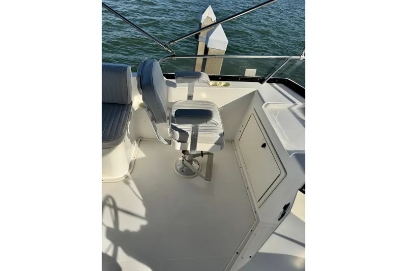 Slide: The Image of 2001 Sabre Sedan Bridge boat deck with seating and railing, overlooking water. - 15