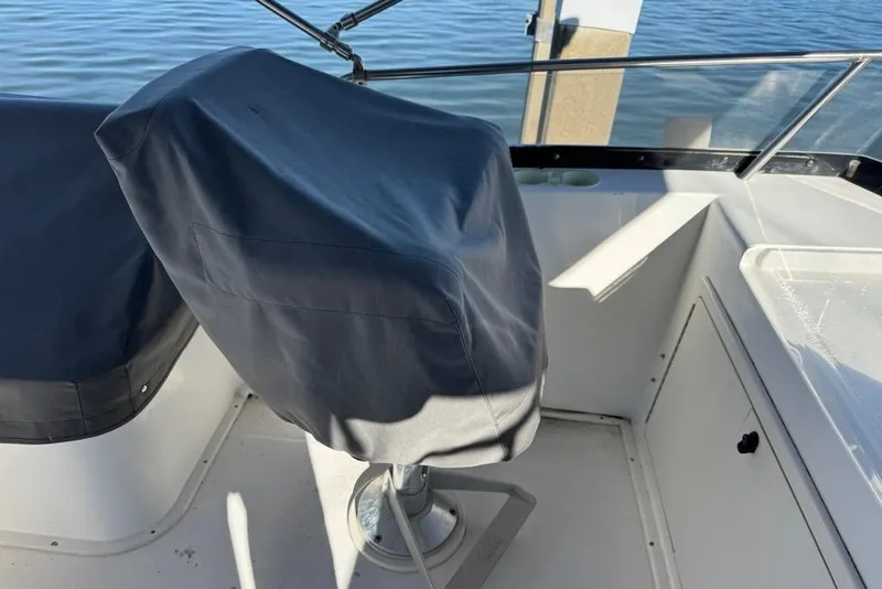 Slide: The Image of 2001 Sabre Sedan Bridge boat helm with covered seats and clear water view. - 21