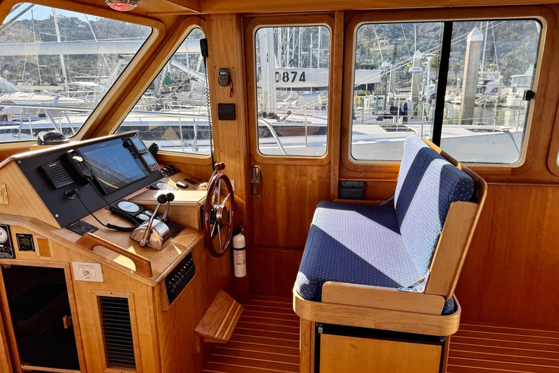 Slide: The Image of Interior of 2001 Sabre Sedan Bridge boat with helm and seating area. - 23