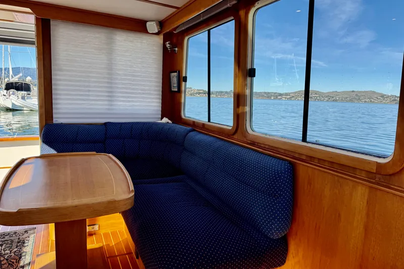 Slide: The Image of Interior of 2001 Sabre Sedan Bridge yacht with blue seating and scenic water view. - 25
