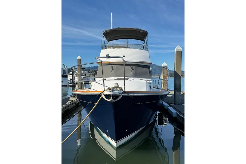 Slide: The Image of 2001 Sabre Sedan Bridge yacht docked at marina under clear blue sky. - 3