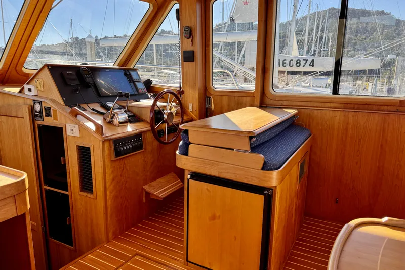 Slide: The Image of Interior of 2001 Sabre Sedan Bridge boat with wooden helm and navigation equipment. - 30