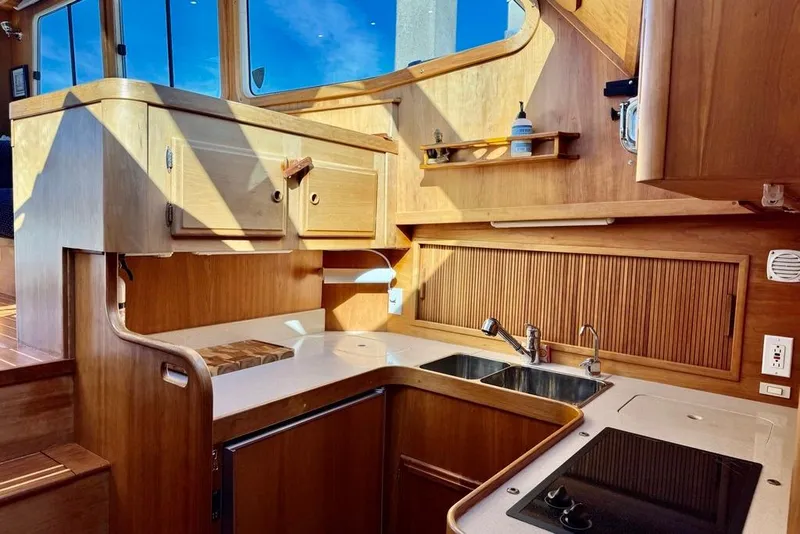 Slide: The Image of 2001 Sabre Sedan Bridge yacht kitchen with wooden cabinetry and modern appliances. - 32