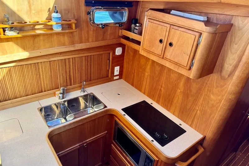 Slide: The Image of Wooden kitchen interior of 2001 Sabre Sedan Bridge with sink and stove. - 33