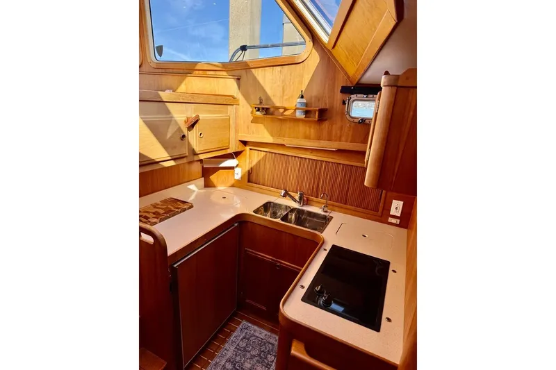 Slide: The Image of 2001 Sabre Sedan Bridge yacht kitchen with wood cabinetry and modern appliances. - 34