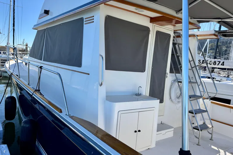 Slide: The Image of 2001 Sabre Sedan Bridge yacht with covered windows and outdoor sink in marina. - 4