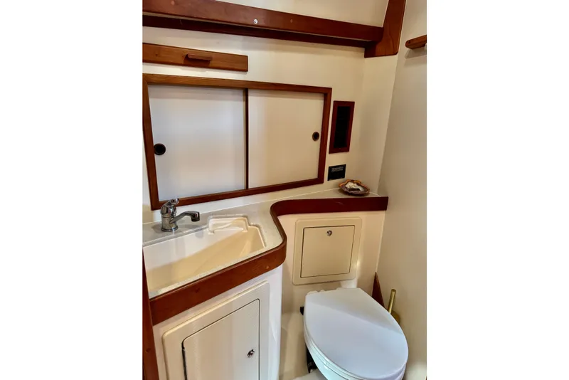 Slide: The Image of 2001 Sabre Sedan Bridge bathroom with sink, toilet, and wooden accents. - 41