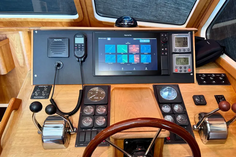 Slide: The Image of 2001 Sabre Sedan Bridge helm with navigation controls and modern display. - 43