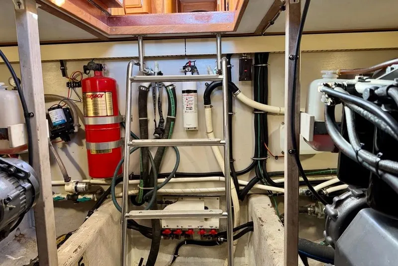 Slide: The Image of Engine room of a 2001 Sabre Sedan Bridge with fire extinguisher and wiring. - 45