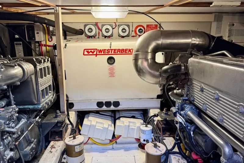 Slide: The Image of Engine room of a 2001 Sabre Sedan Bridge with Westerbeke generator and Yanmar engine components. - 49