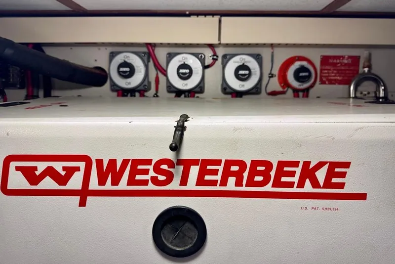 Slide: The Image of Westerbeke generator panel on 2001 Sabre Sedan Bridge boat, featuring control switches. - 51