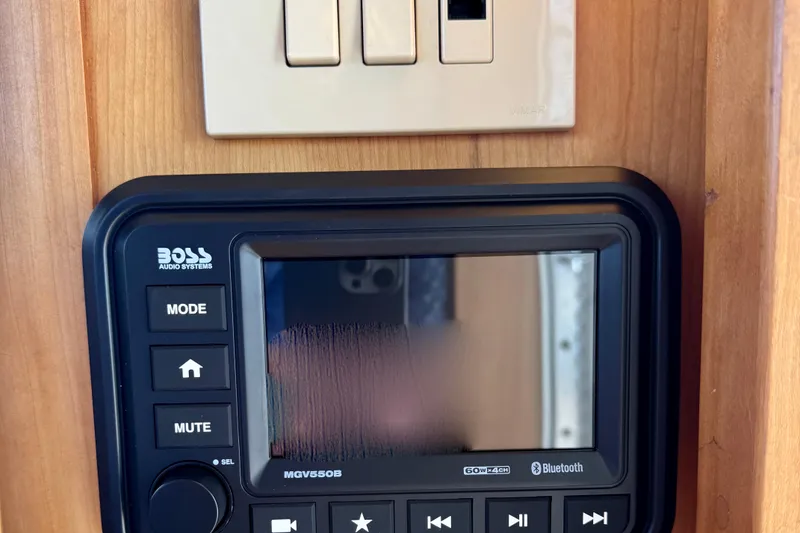 Slide: The Image of Audio system and switch panel on 2001 Sabre Sedan Bridge boat interior. - 55